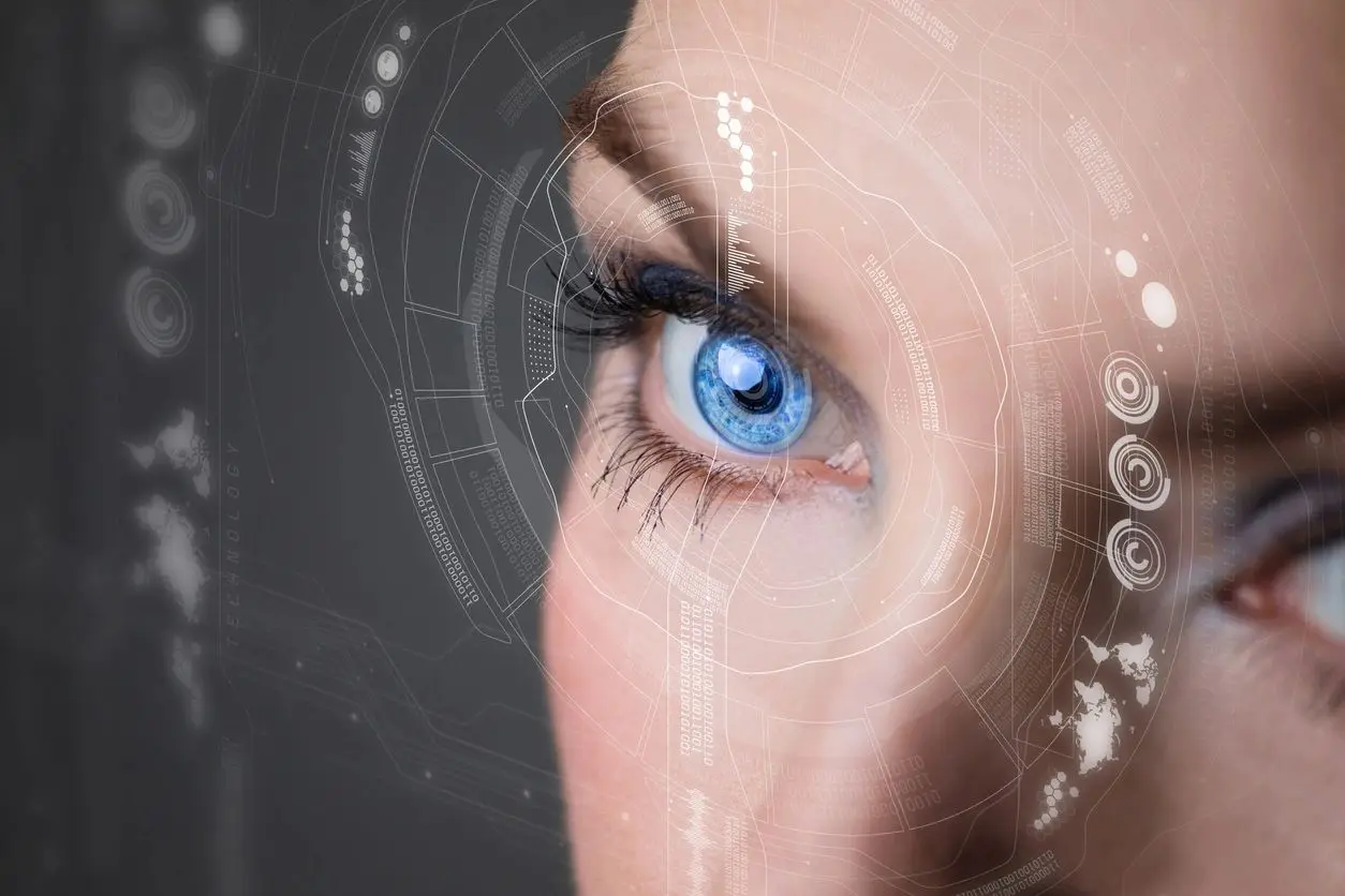An image of a woman's eye with a computer interface.
